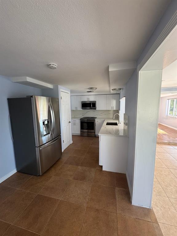 3631 Grayton Drive New Port Richey, FL 34652 - Photo 10 of 42 a kitchen with stainless steel appliances granite countertop a refrigerator a stove top oven a sink and dishwasher