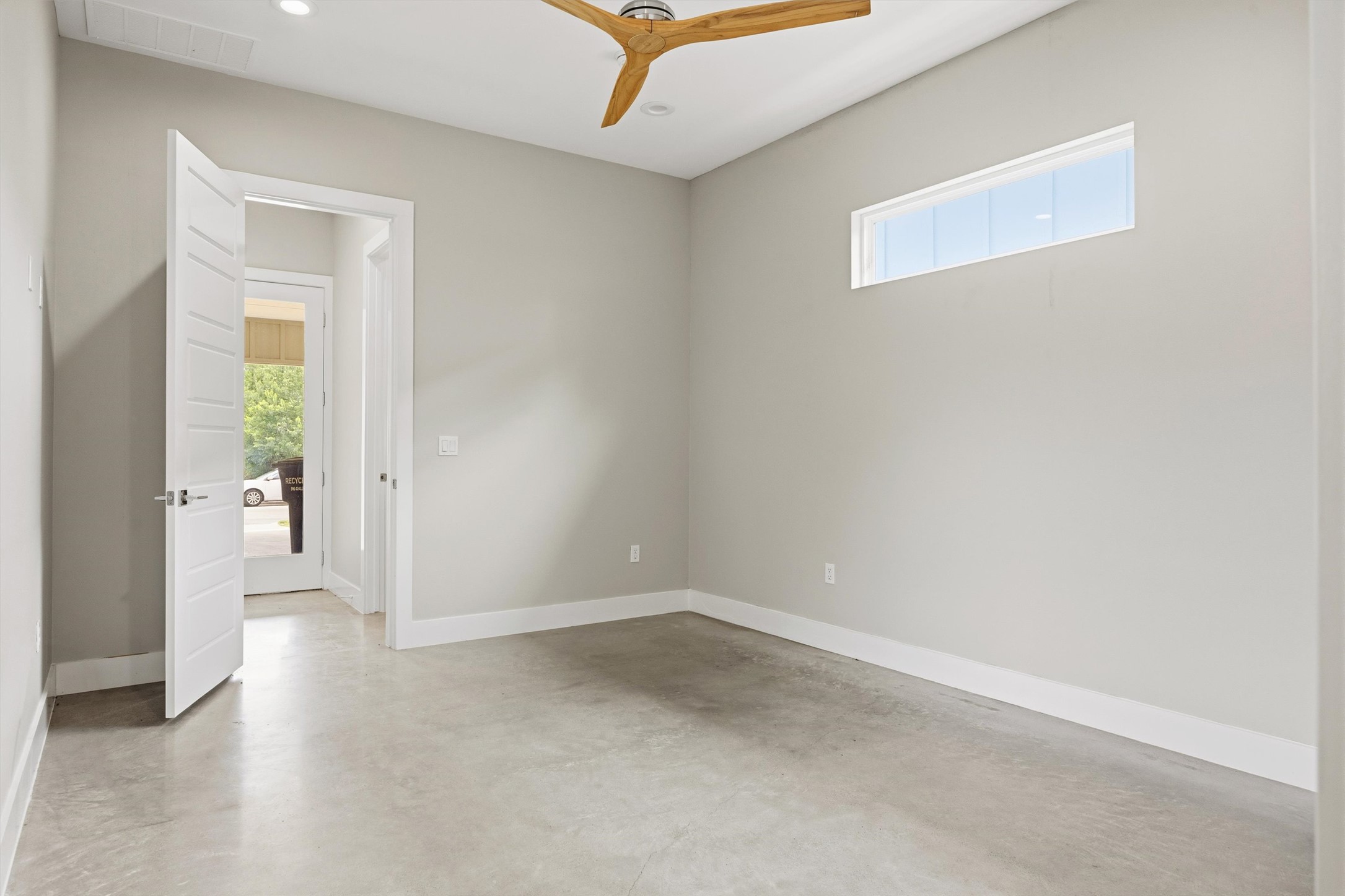 1210 Stobaugh Street, Unit B Austin, TX 78757 - Photo 17 of 40 A well-lit, versatile room with polished concrete flooring and modern wood ceiling fan awaits your personalization.