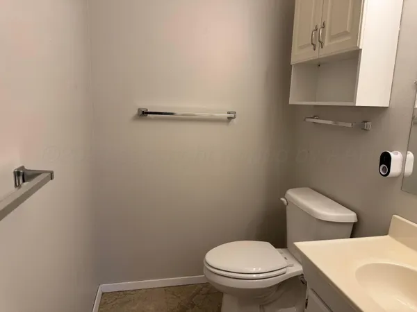 a white toilet sitting next to a bathroom sink