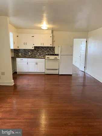 a kitchen with granite countertop a stove and a refrigerator
