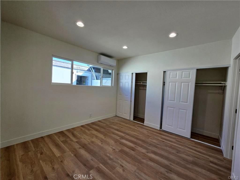 7581 Fillmore Drive, Unit A Buena Park, CA 90620 - Photo 2 of 5 wooden floor in an empty room with a window