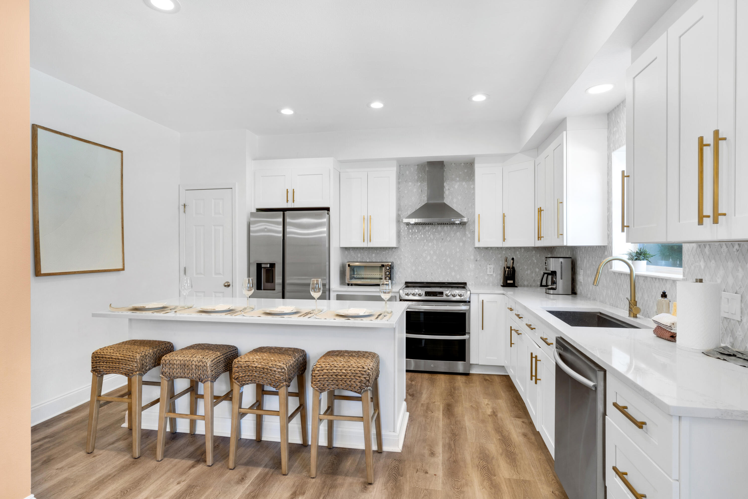 4621 Paradise Isle Destin, FL 32541 - Photo 15 of 65 a kitchen with stainless steel appliances granite countertop a stove top oven a sink a refrigerator and white cabinets
