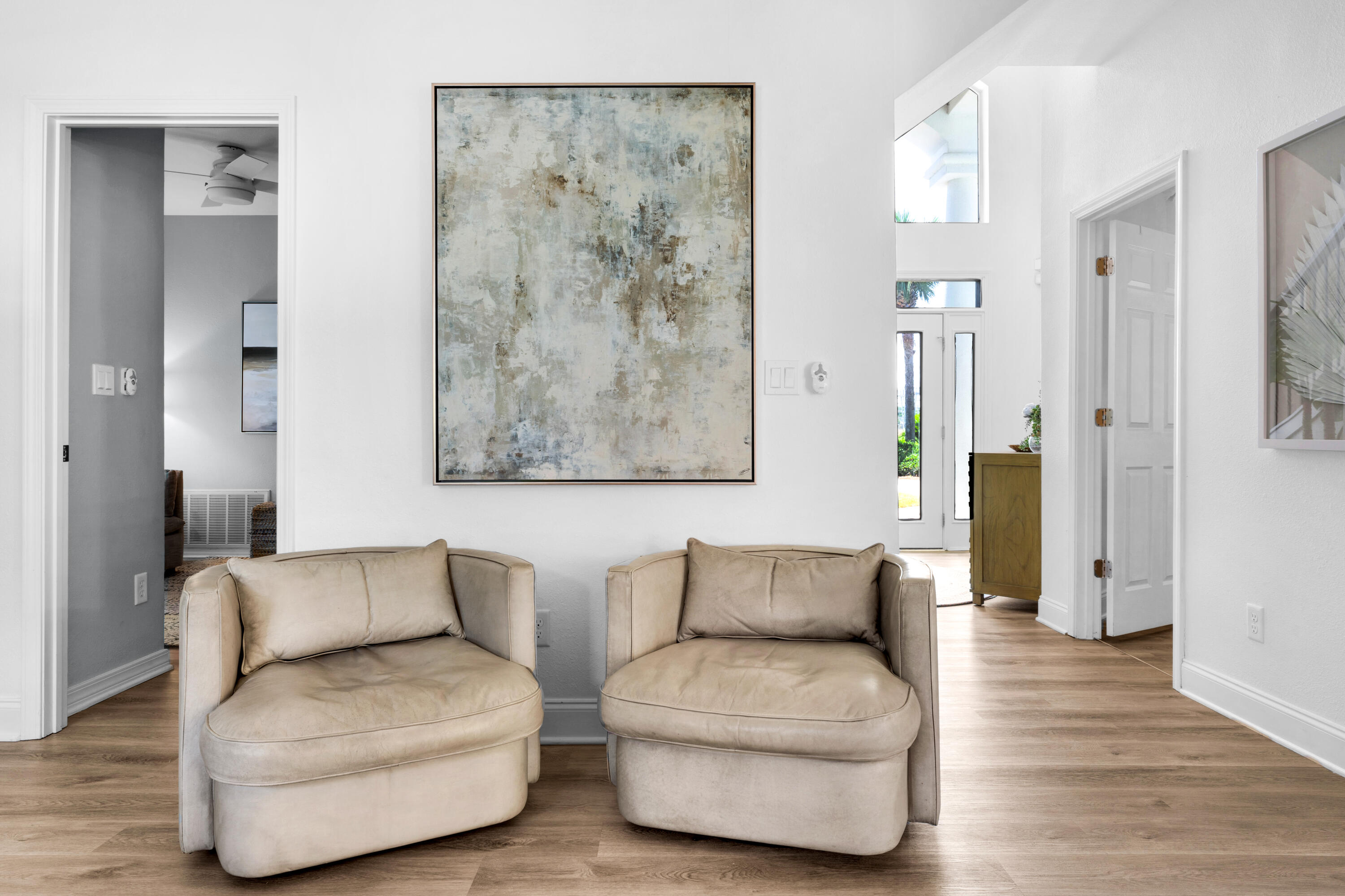 4621 Paradise Isle Destin, FL 32541 - Photo 32 of 65 a living room with furniture and a walk in closet with wooden floor