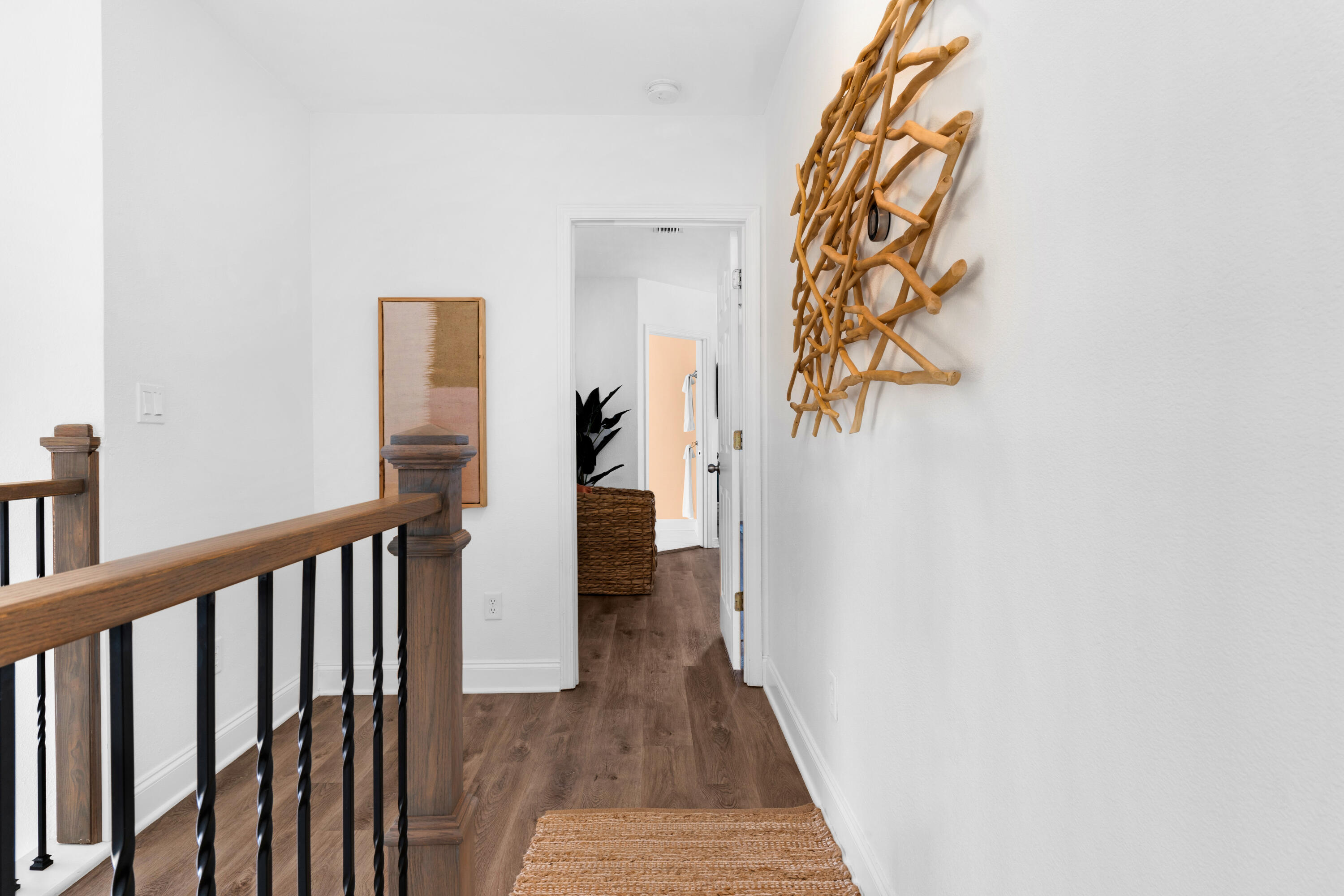 4621 Paradise Isle Destin, FL 32541 - Photo 44 of 65 a view of a hallway with wooden floor and a bathroom