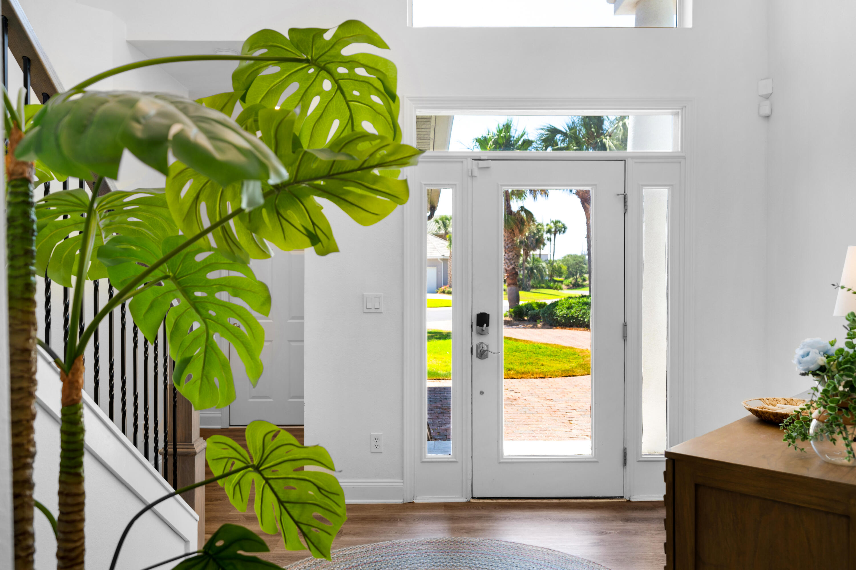 4621 Paradise Isle Destin, FL 32541 - Photo 10 of 65 a view of a dining room with a floor to ceiling window and wooden floor