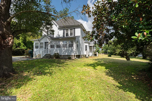 a front view of a house with a yard table and chairs