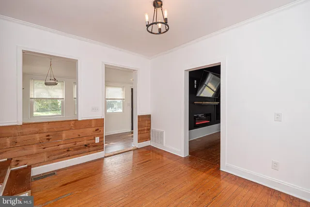 a view of a room with cabinets and wooden floor
