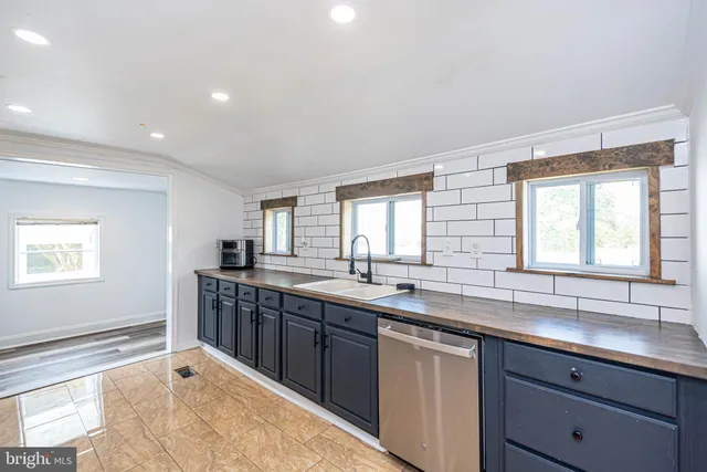 an aerial view of a house with swimming pool and garden