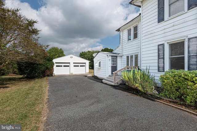 a view of a hallway with wooden floor and closet