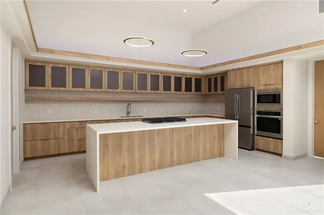 a kitchen with a sink and a stove top oven