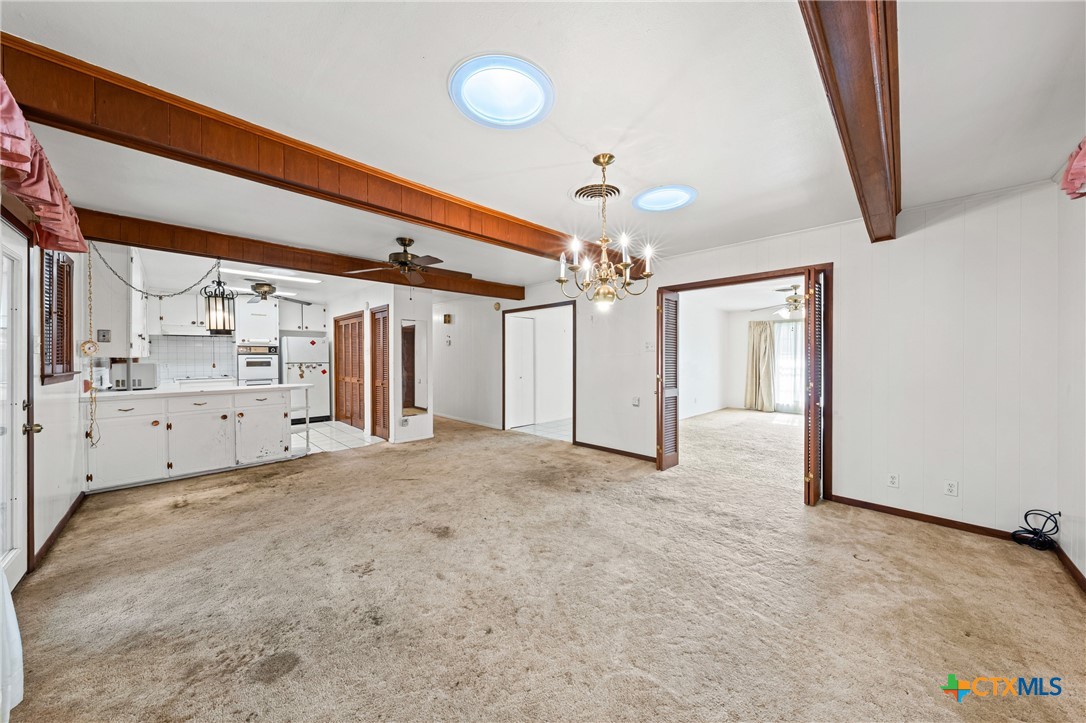 3114 Pecan Drive Temple, TX 76502 - Photo 12 of 32 a view of a hallway with chandelier and utility room