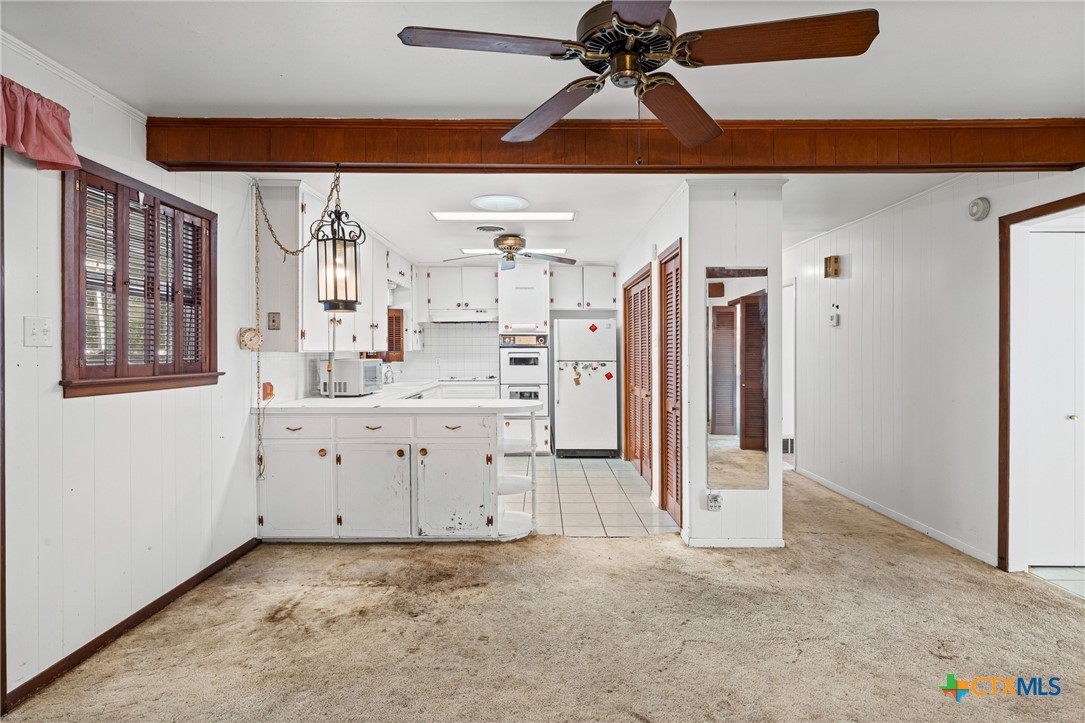 3114 Pecan Drive Temple, TX 76502 - Photo 13 of 32 a view of a kitchen with cabinet and a ceiling fan