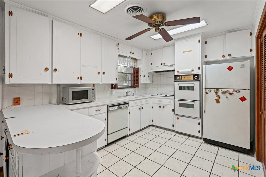 3114 Pecan Drive Temple, TX 76502 - Photo 14 of 32 a kitchen with appliances cabinets and furniture
