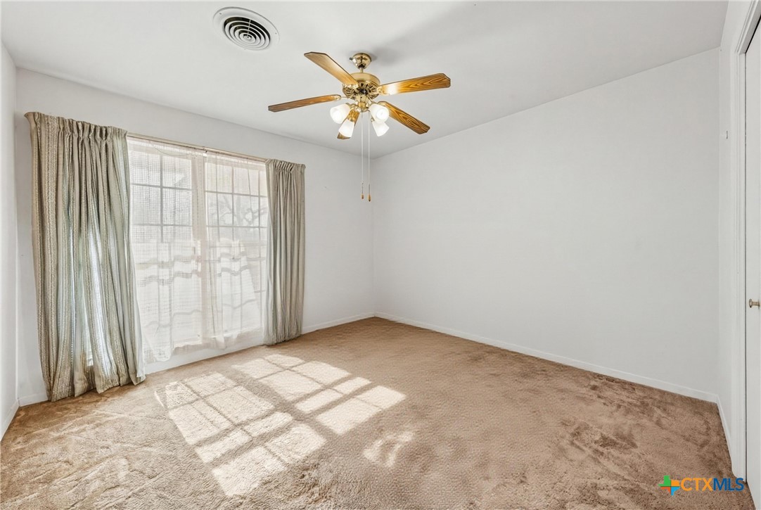 3114 Pecan Drive Temple, TX 76502 - Photo 16 of 32 an empty room with windows and fan
