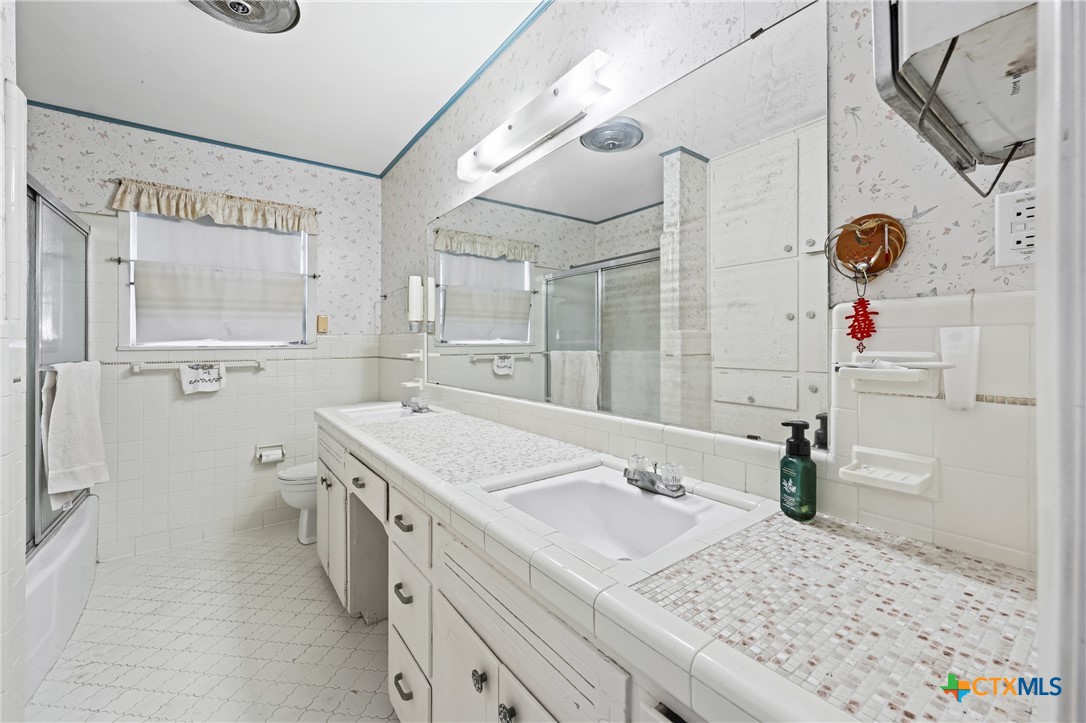 3114 Pecan Drive Temple, TX 76502 - Photo 18 of 32 a bathroom with a sink a vanity and a mirror