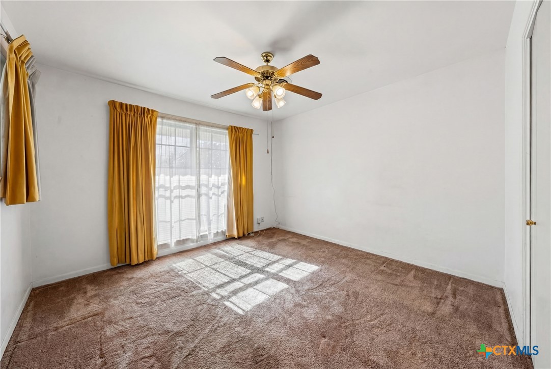 3114 Pecan Drive Temple, TX 76502 - Photo 20 of 32 a view of a big room with windows and chandelier fan