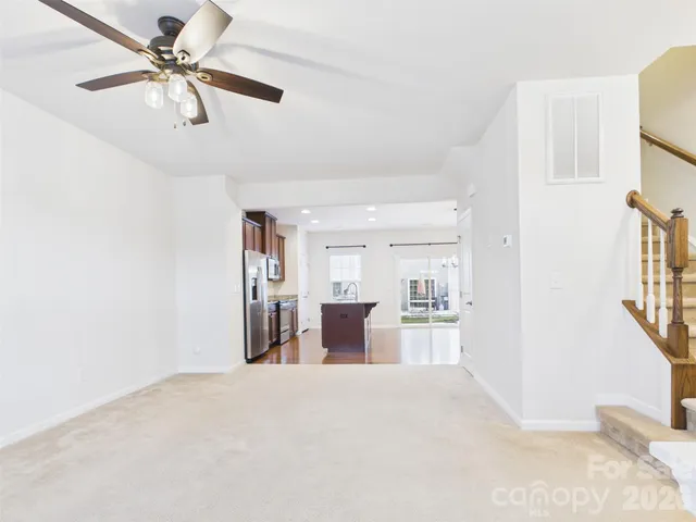 a view of a kitchen with a sink and a refrigerator