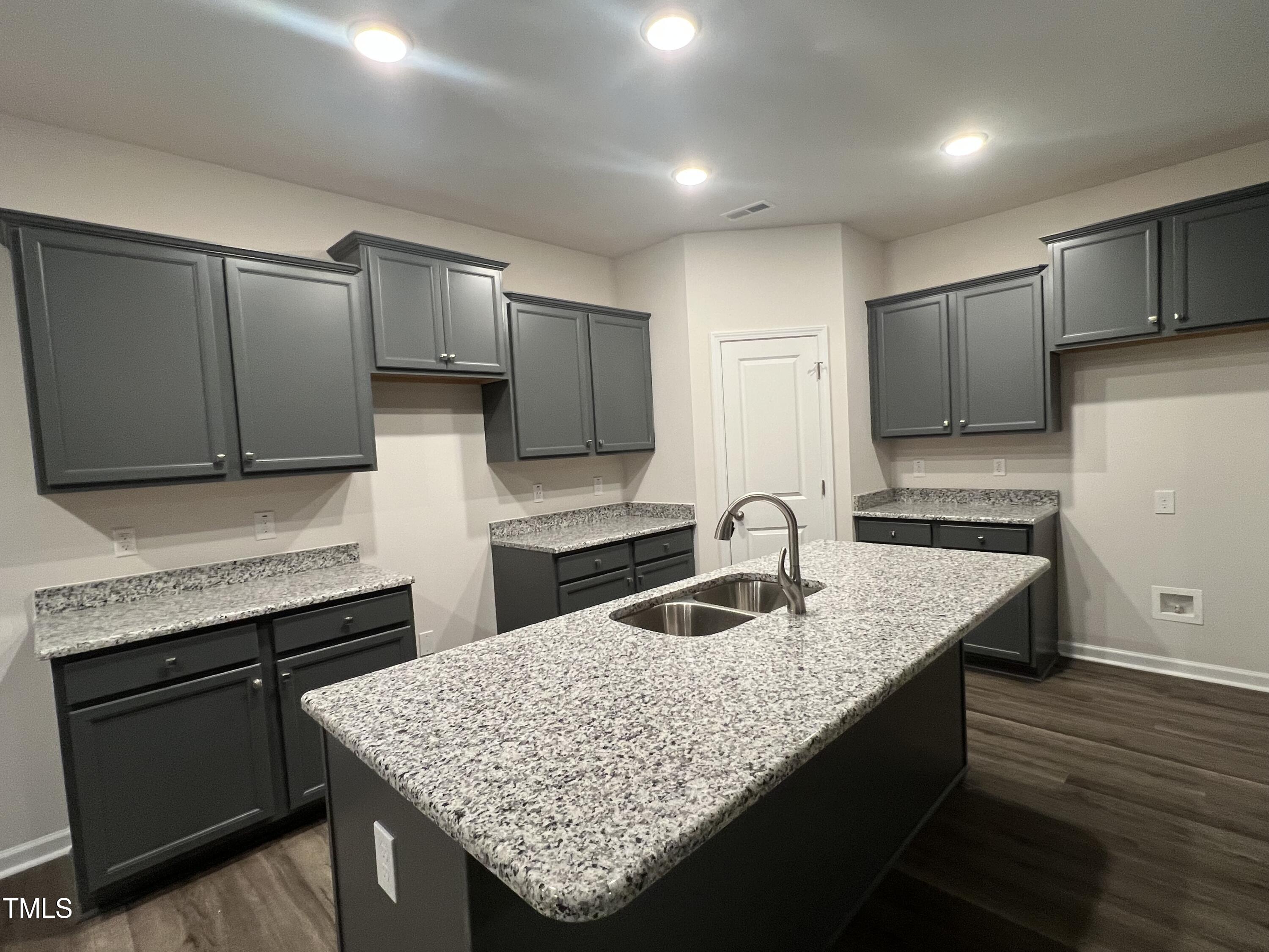259 Palomo Place Raeford, NC 28376 - Photo 5 of 23 a kitchen with granite countertop kitchen island a sink appliances and cabinets