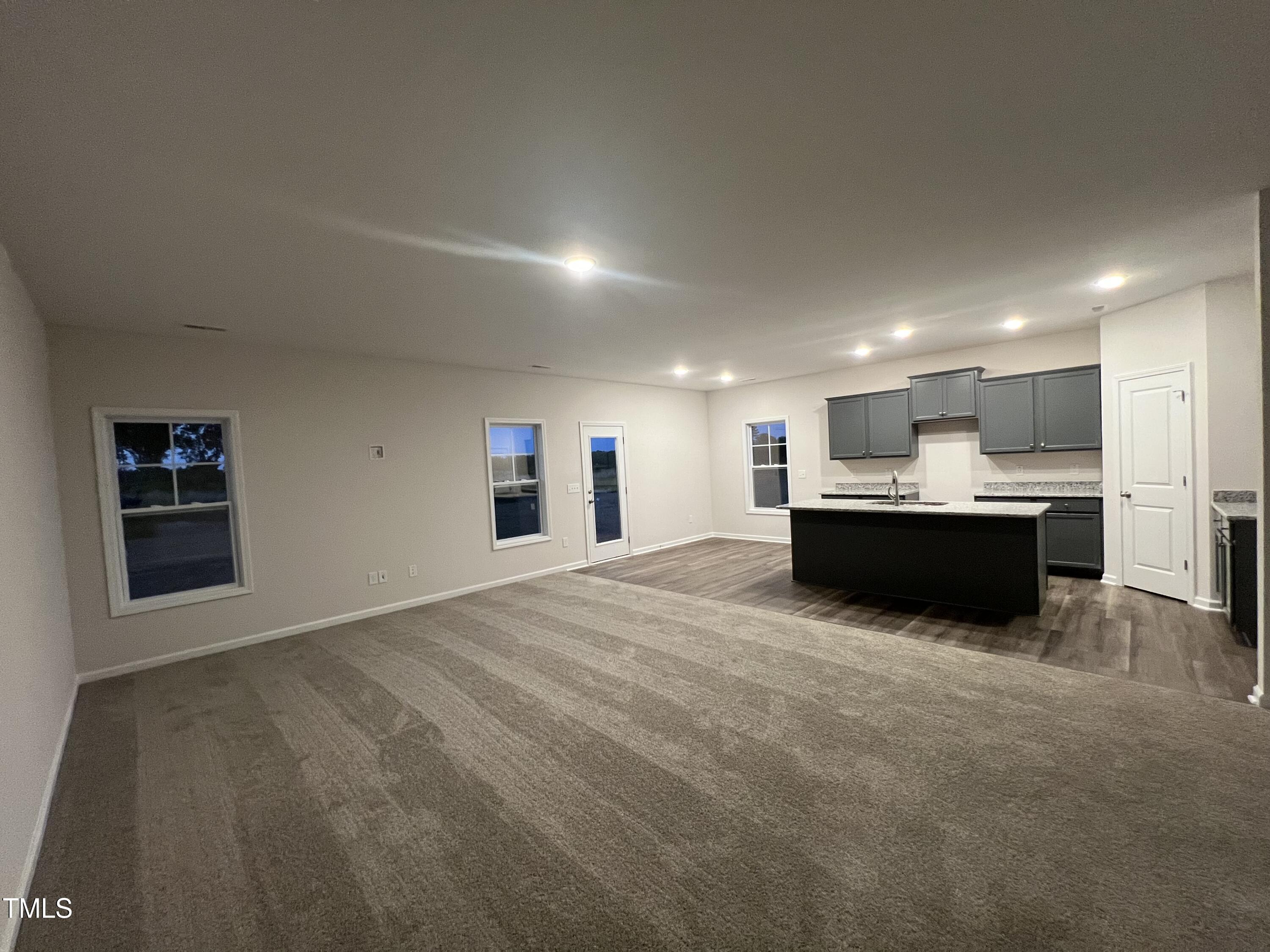 259 Palomo Place Raeford, NC 28376 - Photo 6 of 23 a kitchen with stainless steel appliances granite countertop a sink a stove and a refrigerator