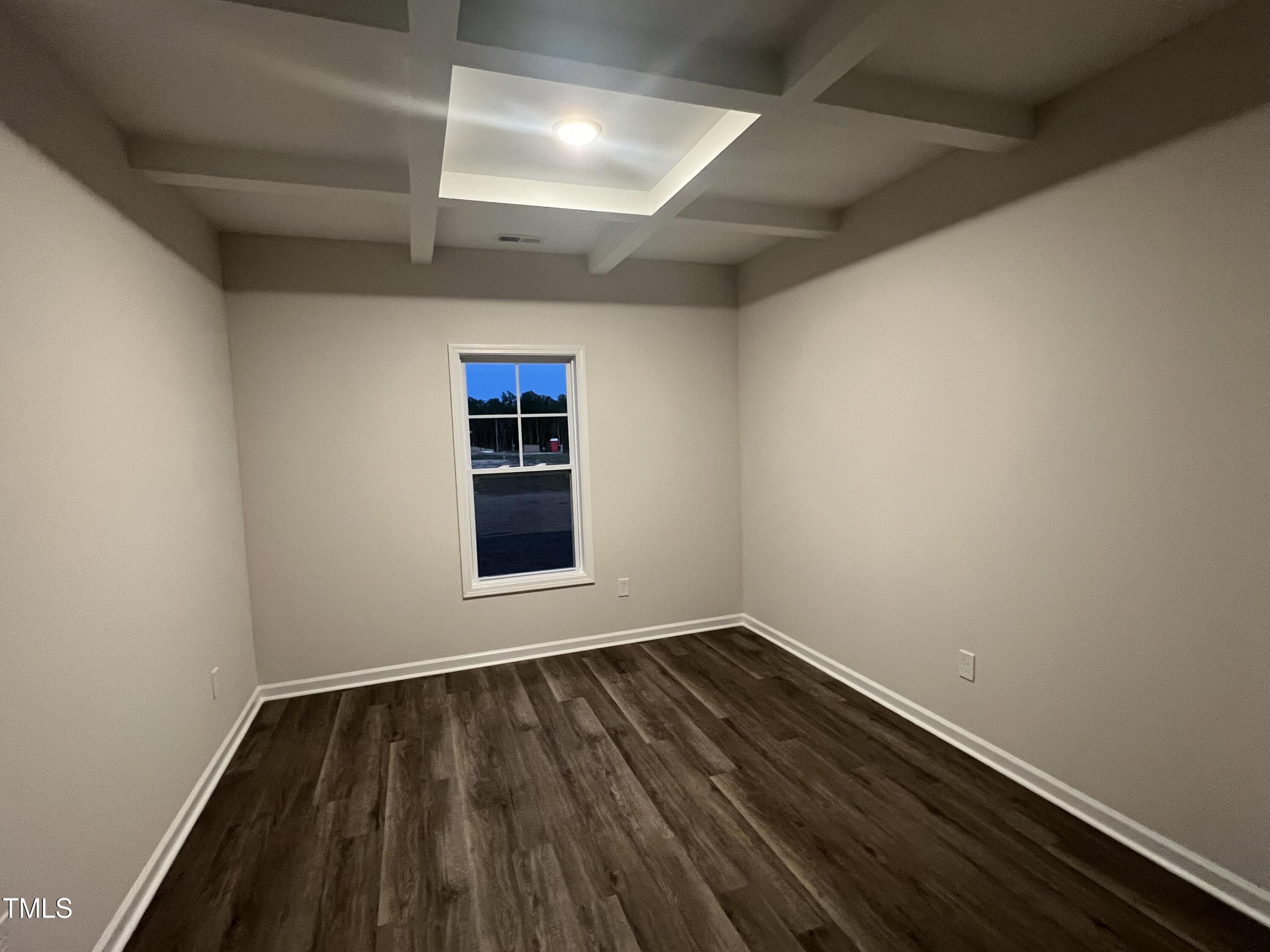 259 Palomo Place Raeford, NC 28376 - Photo 8 of 23 a view of an empty room with wooden floor and a window