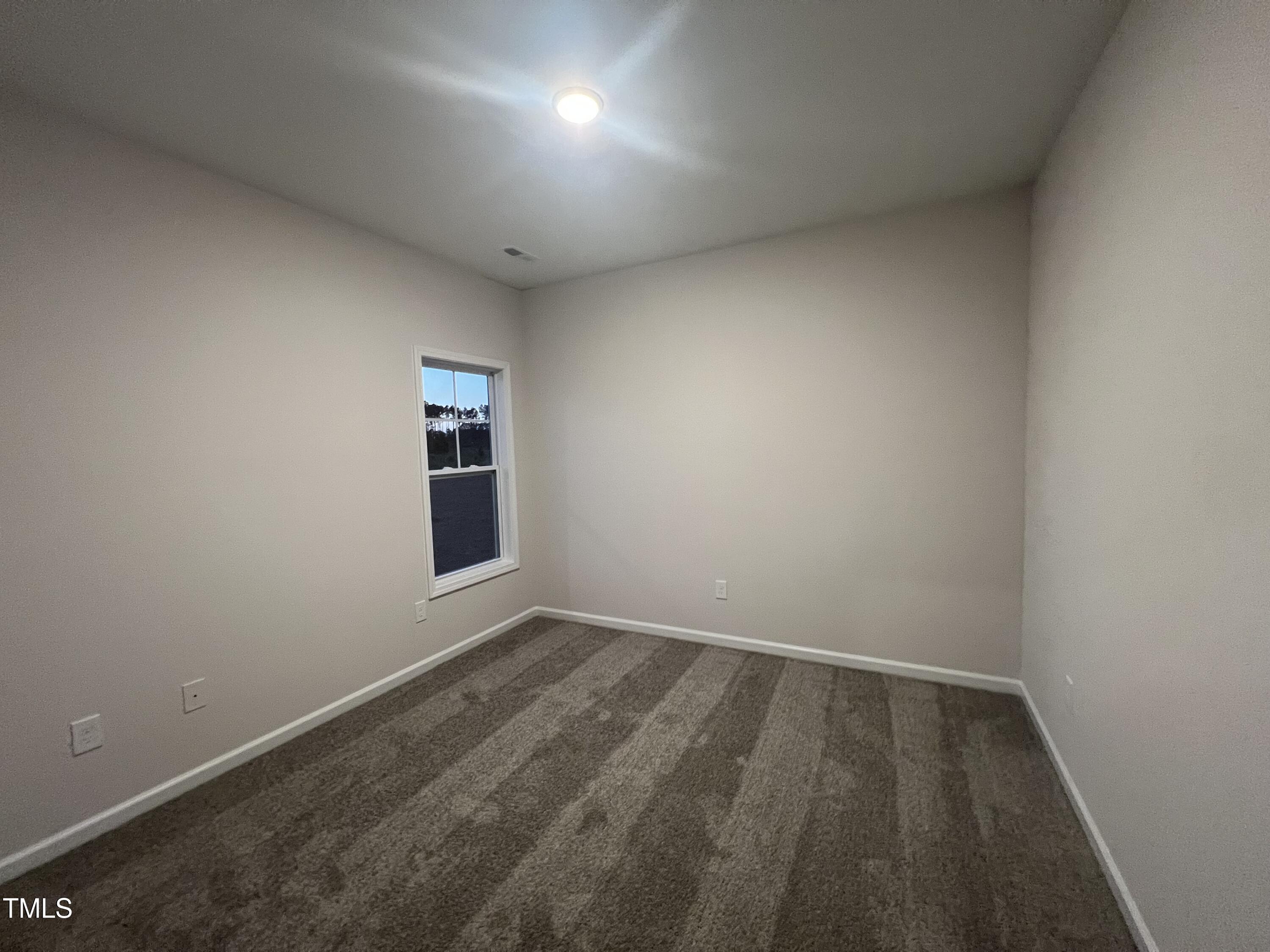 259 Palomo Place Raeford, NC 28376 - Photo 9 of 23 an empty room with a empty space and windows