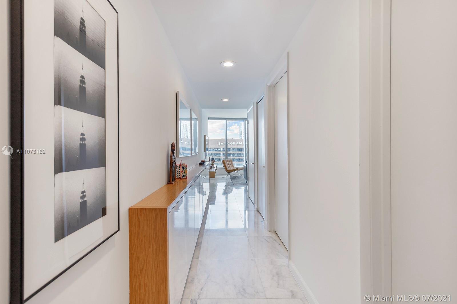485 Brickell Avenue, Unit 4108 Miami, FL 33131 - Photo 2 of 21 a view of a hallway with wooden floor and a living room