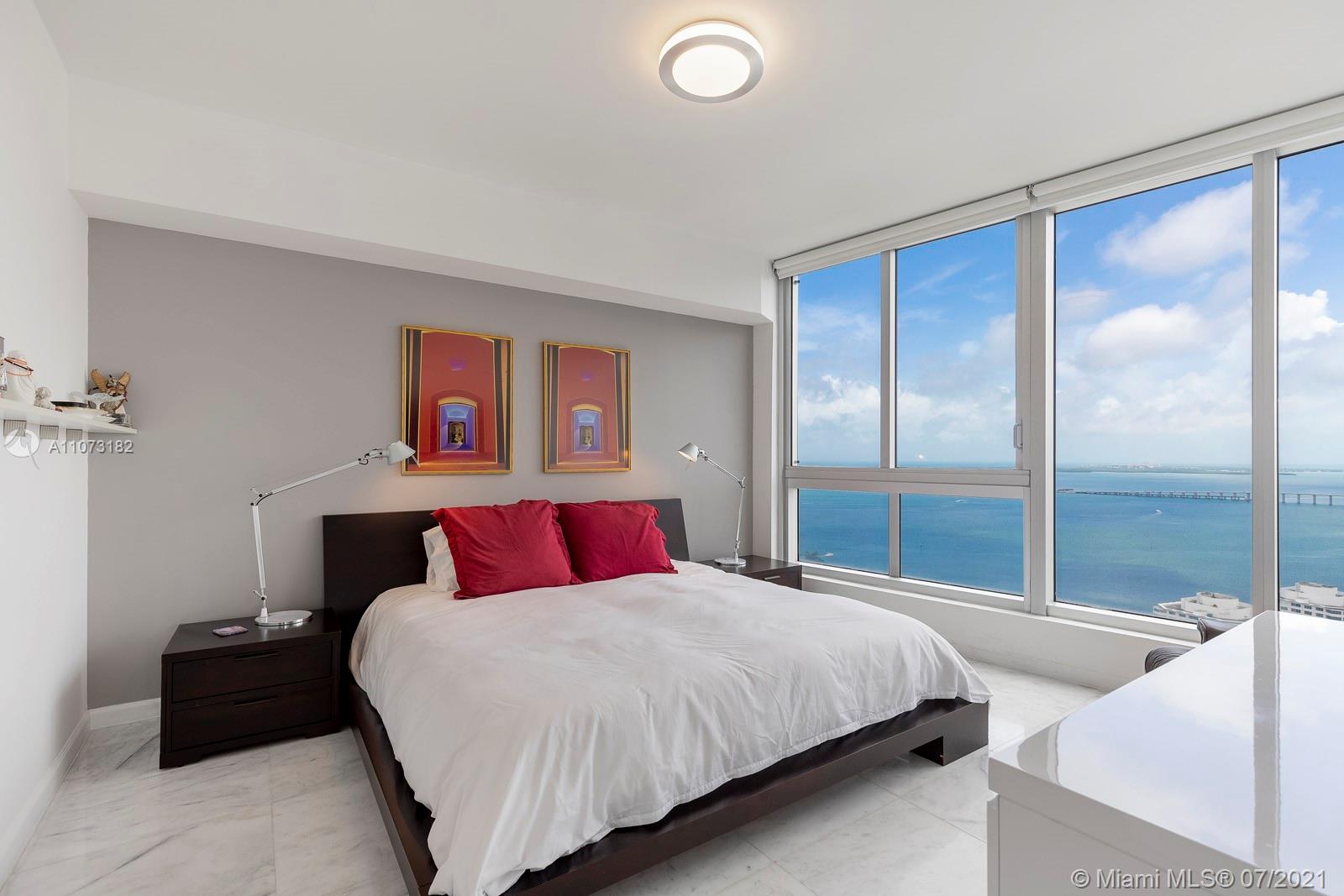485 Brickell Avenue, Unit 4108 Miami, FL 33131 - Photo 11 of 21 a bedroom with a large bed and a balcony view