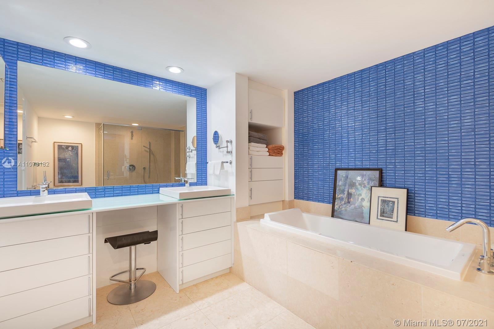 485 Brickell Avenue, Unit 4108 Miami, FL 33131 - Photo 12 of 21 a bathroom with a sink a bathtub and a double vanity sink