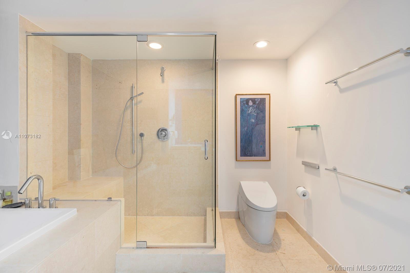 485 Brickell Avenue, Unit 4108 Miami, FL 33131 - Photo 13 of 21 a bathroom with a shower sink vanity and toilet