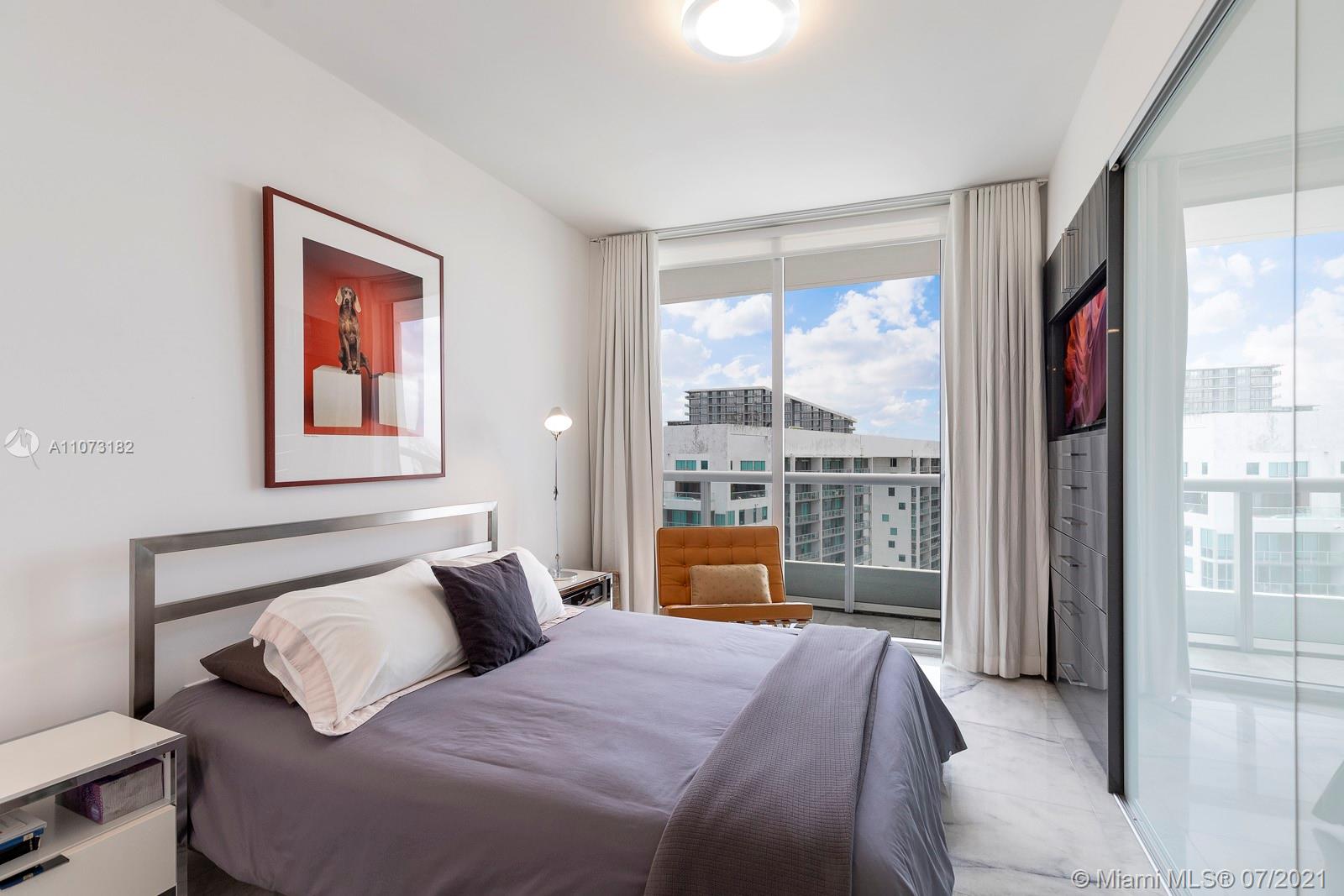 485 Brickell Avenue, Unit 4108 Miami, FL 33131 - Photo 15 of 21 a bedroom with a large bed and a balcony