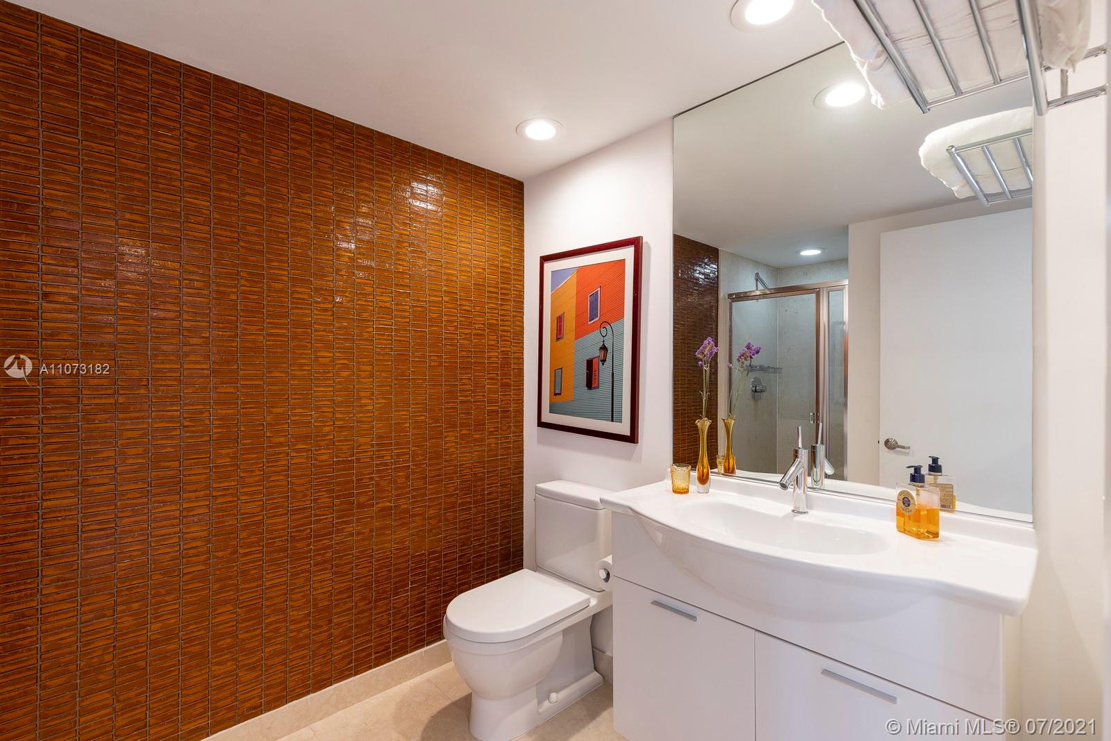 485 Brickell Avenue, Unit 4108 Miami, FL 33131 - Photo 17 of 21 a bathroom with a sink mirror vanity and toilet