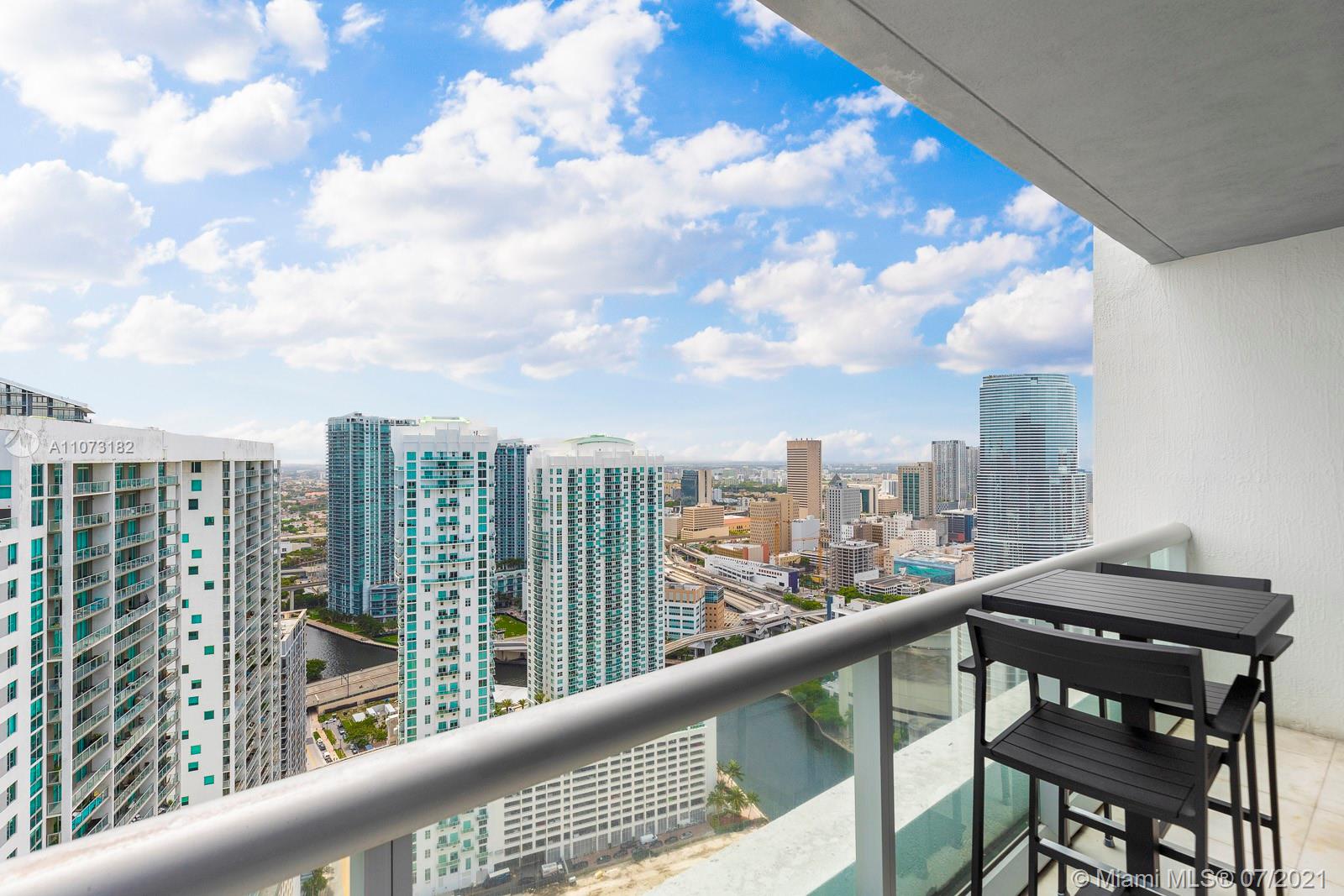 485 Brickell Avenue, Unit 4108 Miami, FL 33131 - Photo 18 of 21 a view of a balcony with a table and chairs