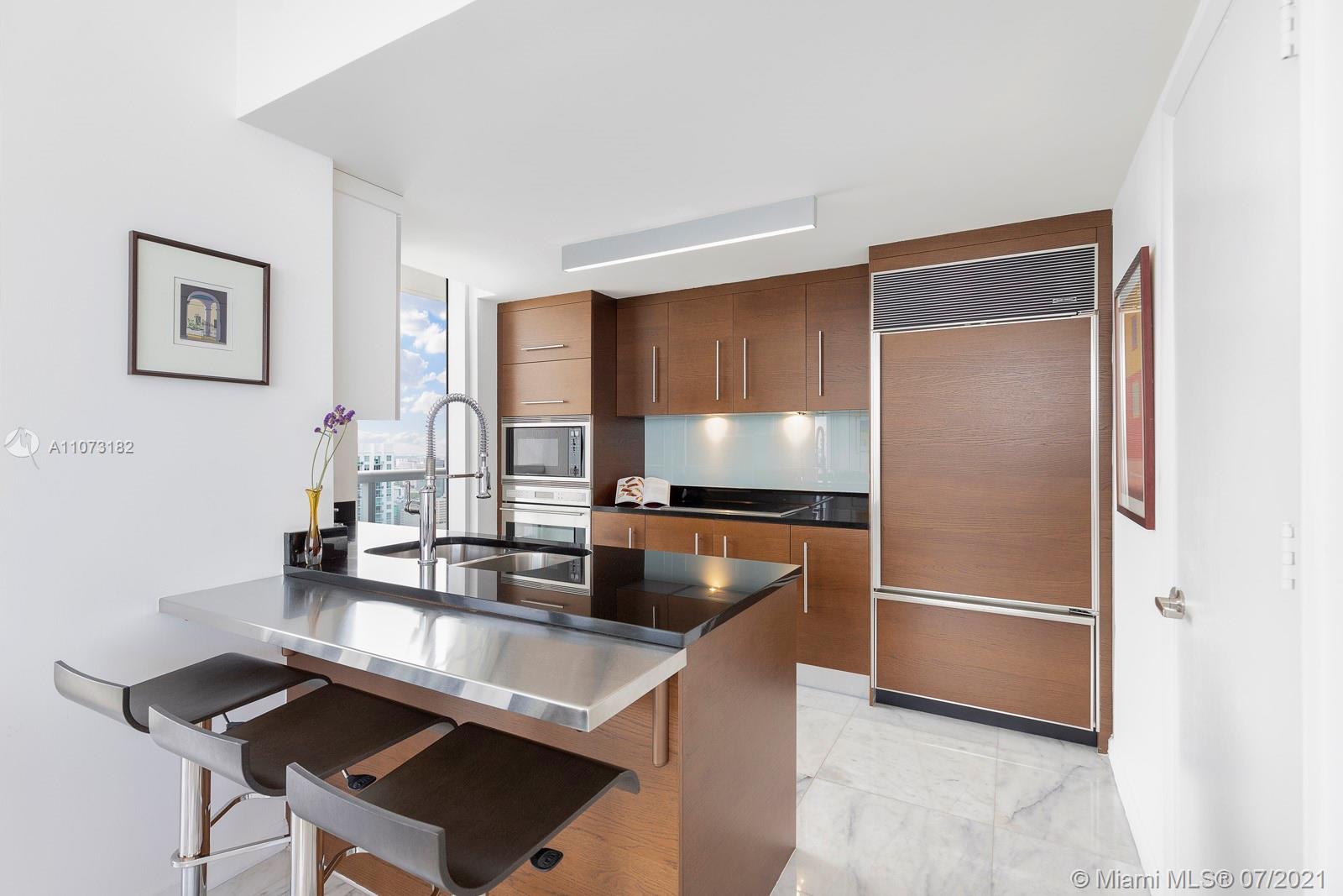 485 Brickell Avenue, Unit 4108 Miami, FL 33131 - Photo 9 of 21 a kitchen with kitchen island a sink stove and refrigerator