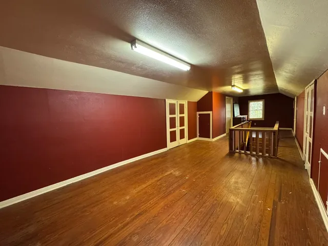 a dining room with furniture and view of kitchen