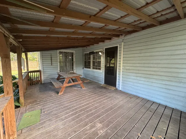 a sitting area with furniture on wooden floor