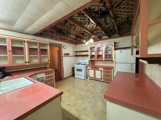 a room with furniture and stainless steel appliances