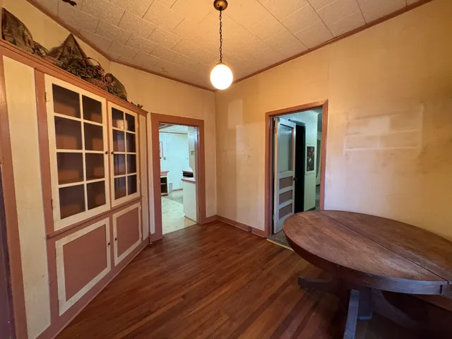 a view of a room with wooden floor and windows