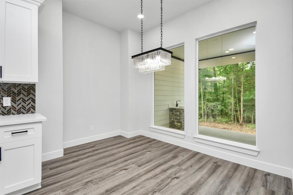 12163 La Salle River Road Conroe, TX 77304 - Photo 16 of 27 a view of an empty room with wooden floor and a window