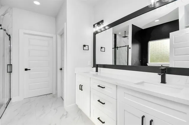 a bathroom with a double vanity sink and mirror