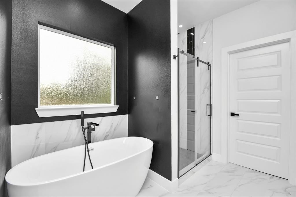 12163 La Salle River Road Conroe, TX 77304 - Photo 19 of 27 a white bath tub sitting next to a window