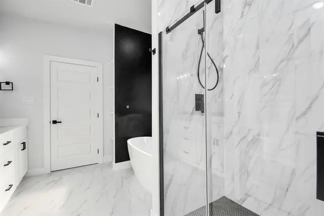 a bathroom with a glass shower door