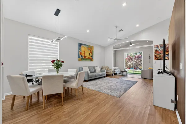 a view of a dining room with furniture window and wooden floor