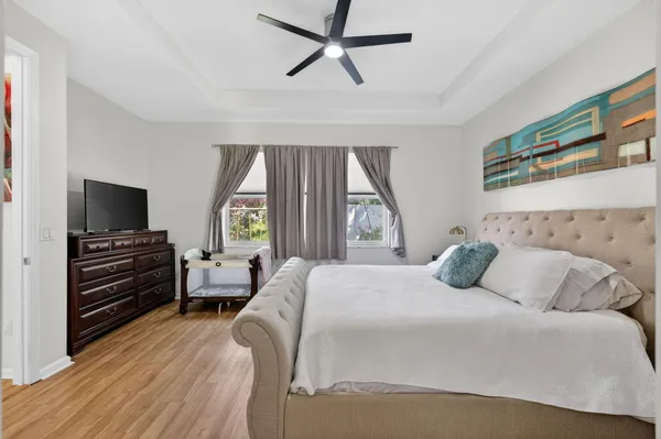a spacious bedroom with a bed and a television