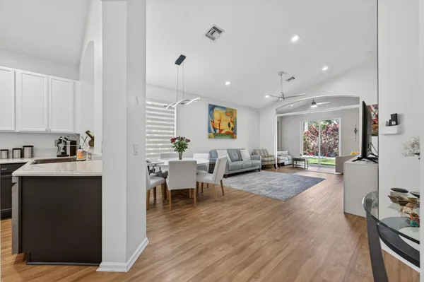 a kitchen with stainless steel appliances a sink dishwasher a refrigerator a stove top oven a counter space and cabinets
