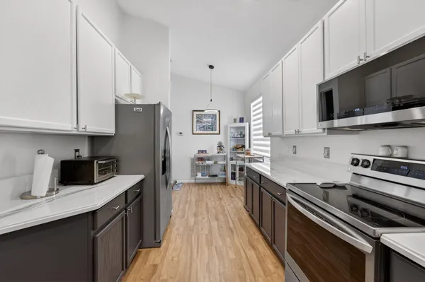 a kitchen that has a sink and a stove in it