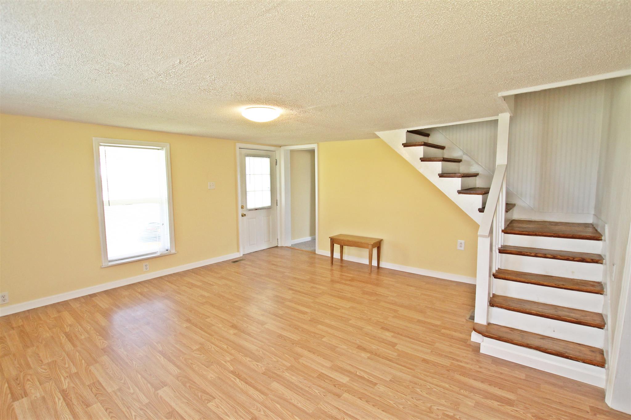 4323 Dot Road Springfield, TN 37172 - Photo 4 of 24 a view of an empty room with wooden floor and a window