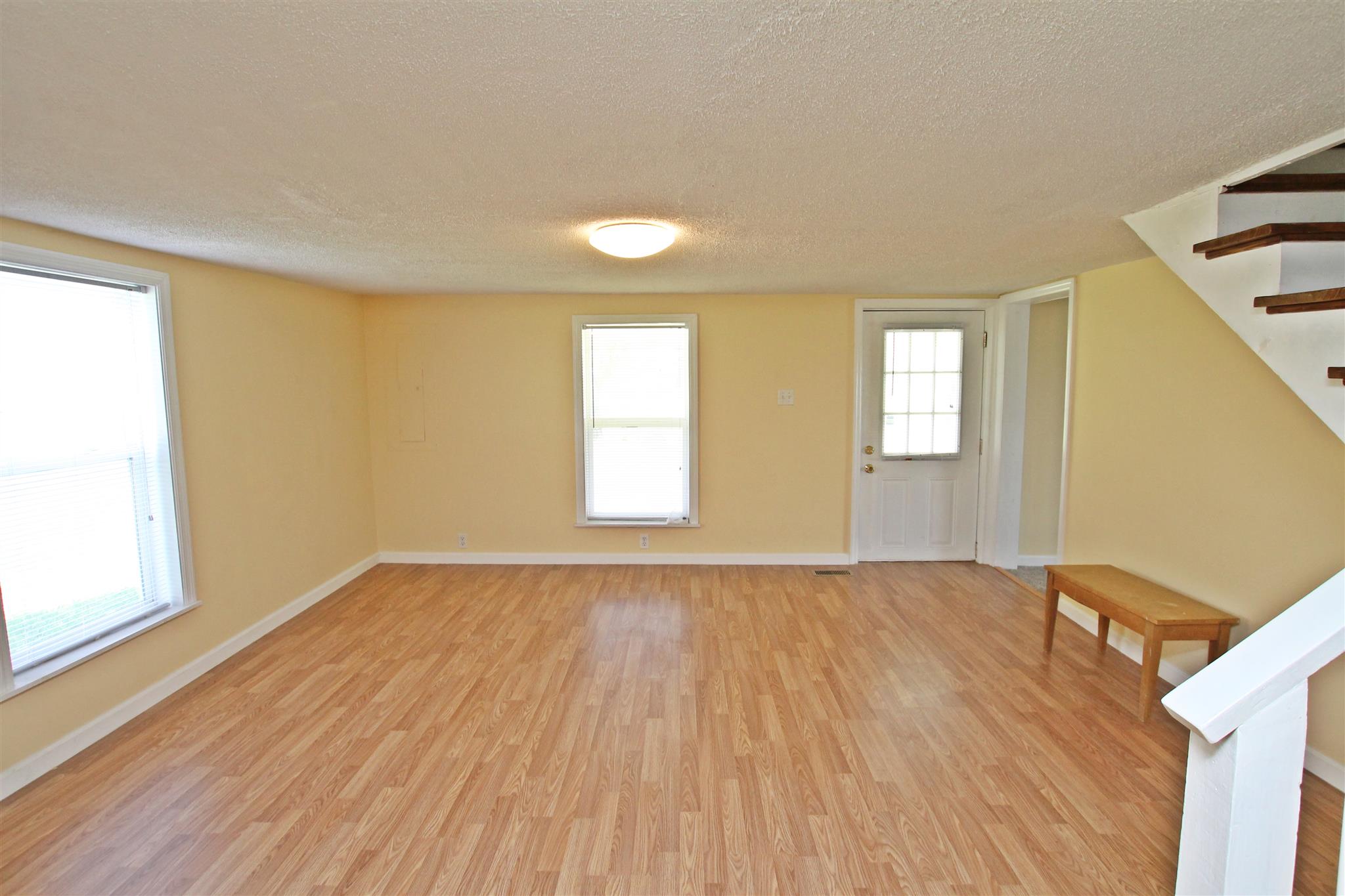 4323 Dot Road Springfield, TN 37172 - Photo 5 of 24 a view of an empty room with wooden floor and a window