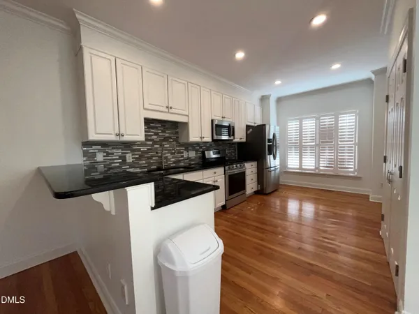 a kitchen with granite countertop a stove and a sink
