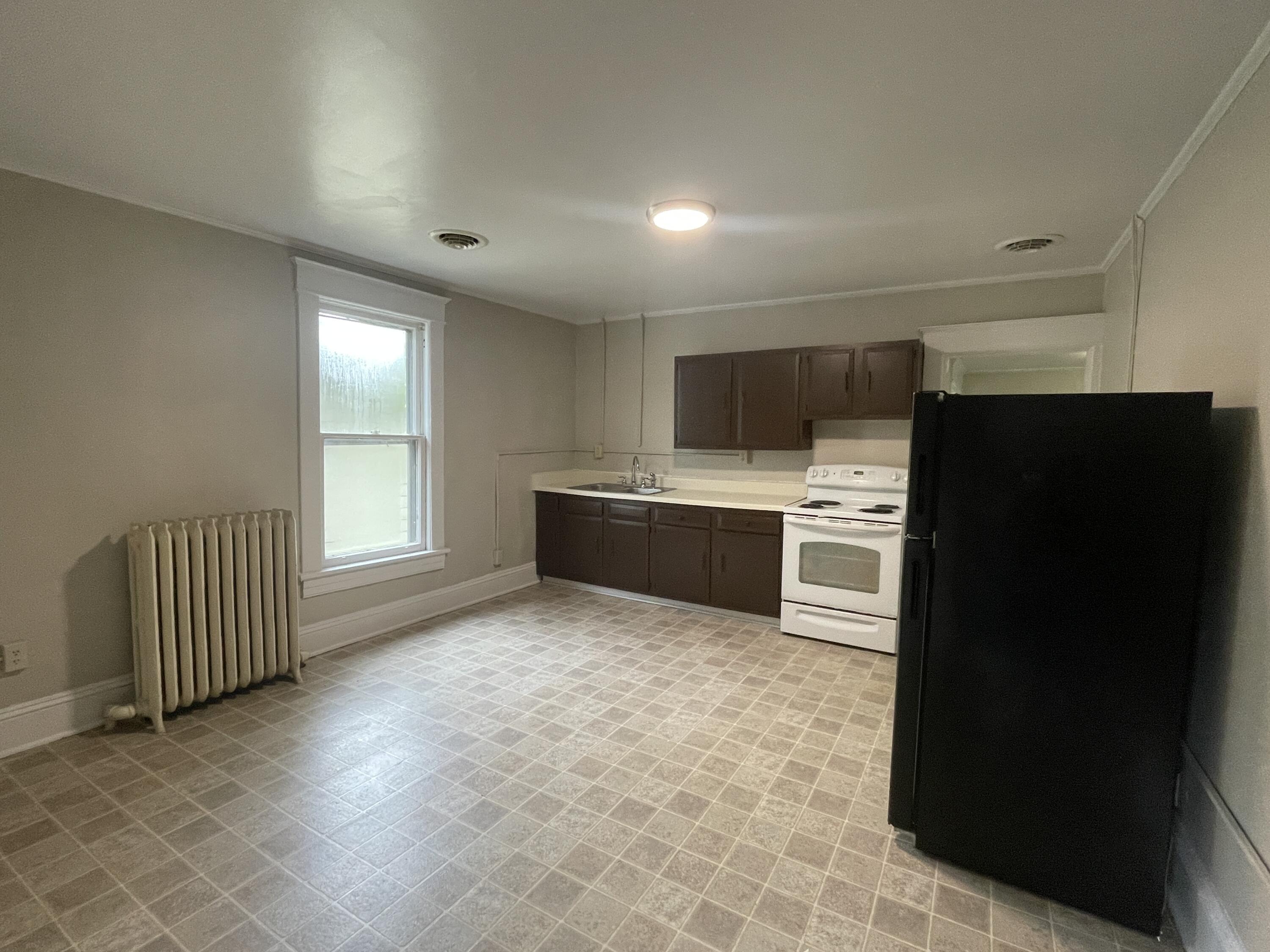 367 Mountain Avenue Southwest, Unit 4 Roanoke, VA 24016 - Photo 4 of 5 a kitchen with stainless steel appliances a refrigerator and a sink