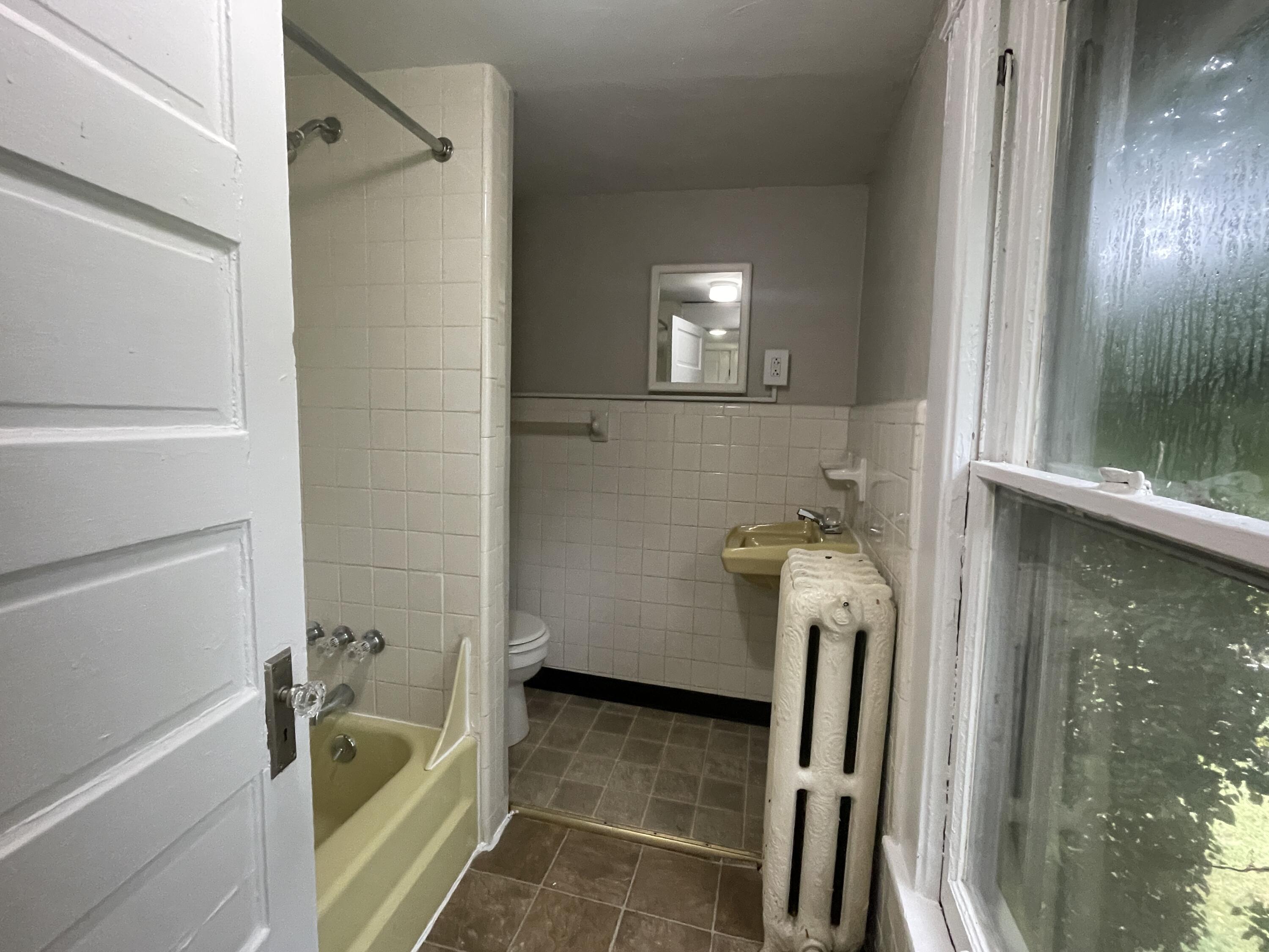 367 Mountain Avenue Southwest, Unit 4 Roanoke, VA 24016 - Photo 5 of 5 a bathroom with a tub and a shower